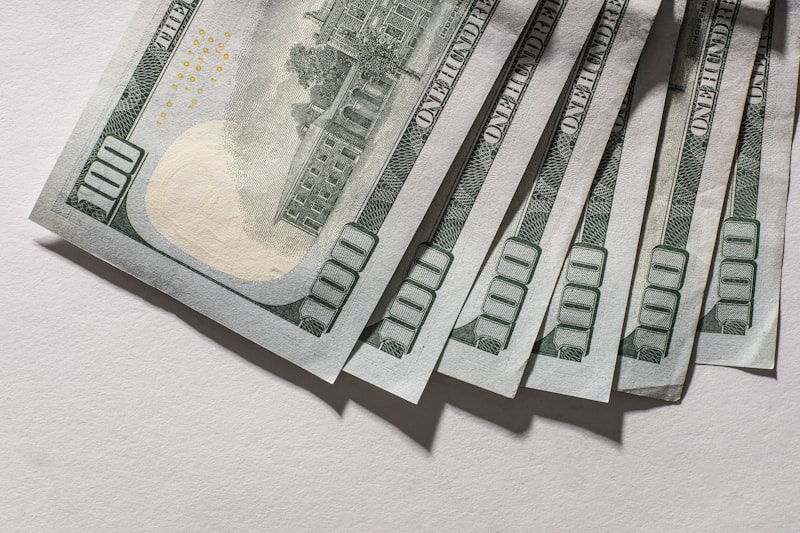 A collection of U.S. dollar bills fanned out, showing various denominations that collectors look for when buying paper currency